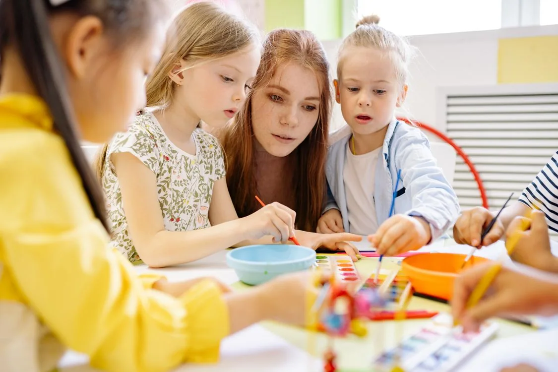 Children painting together during a creative activity