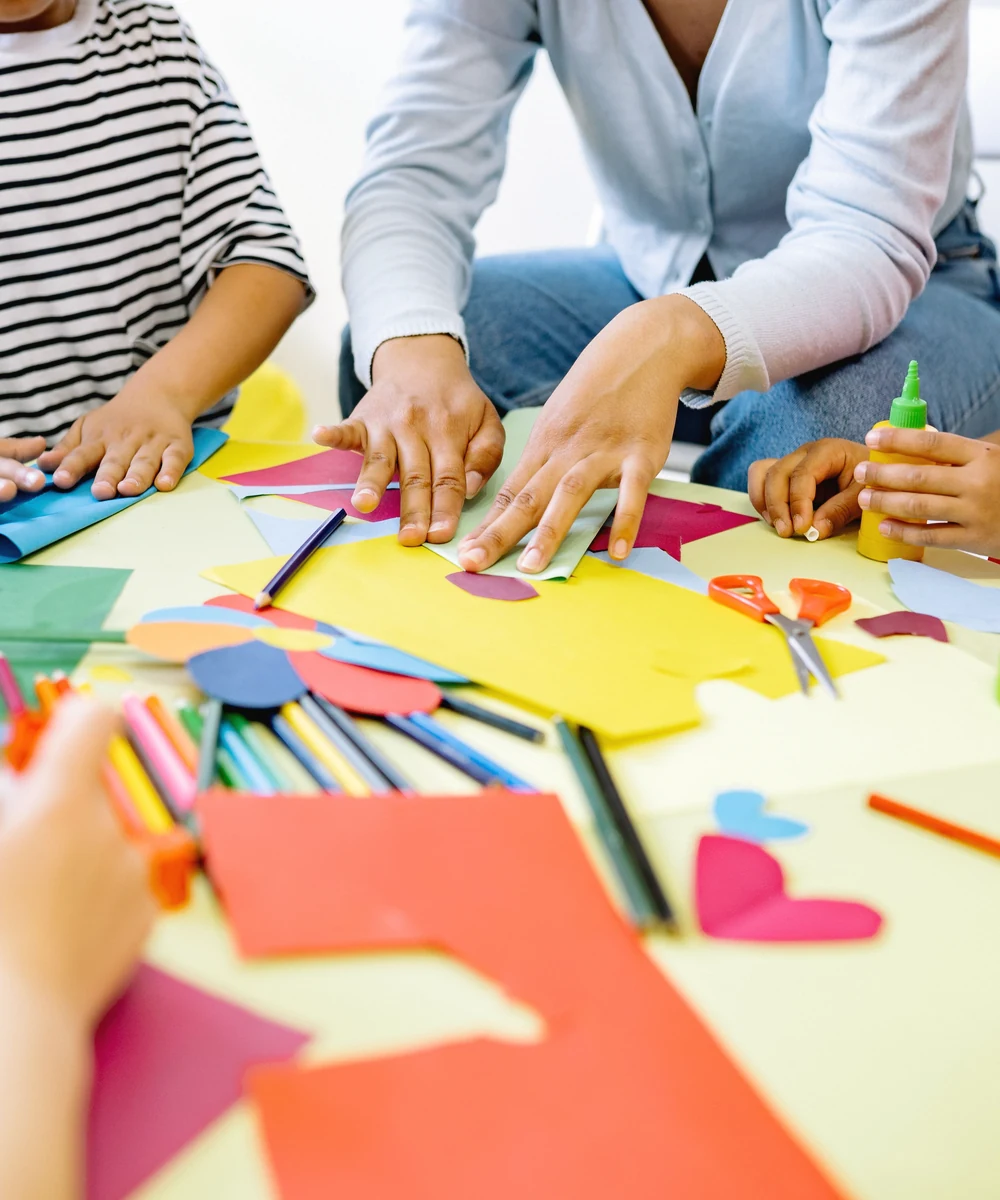 Children and an adult creating colorful art together
