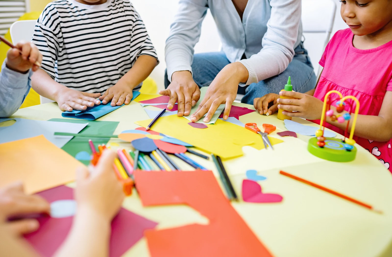 Children and an adult creating colorful art together